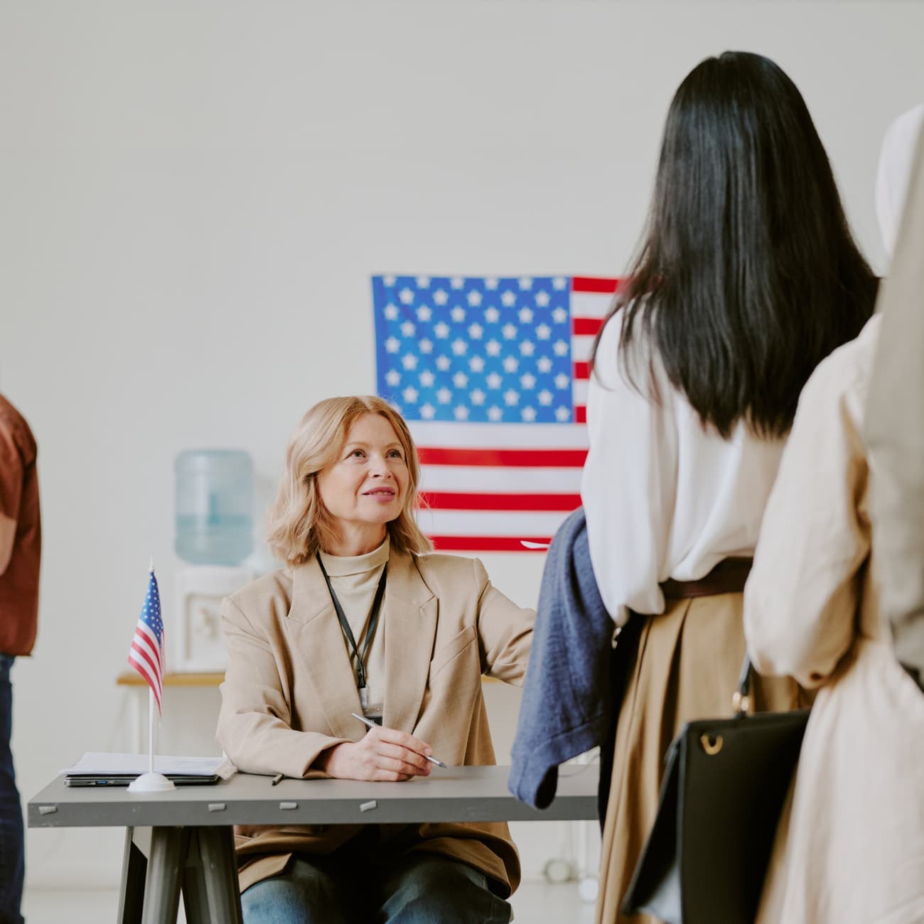 Adviser meeting with clients in front of a U.S. flag